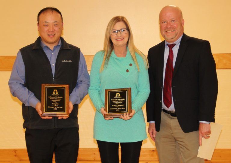 3 people posing with awards