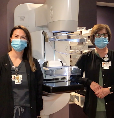 Doctors standing around a machine
