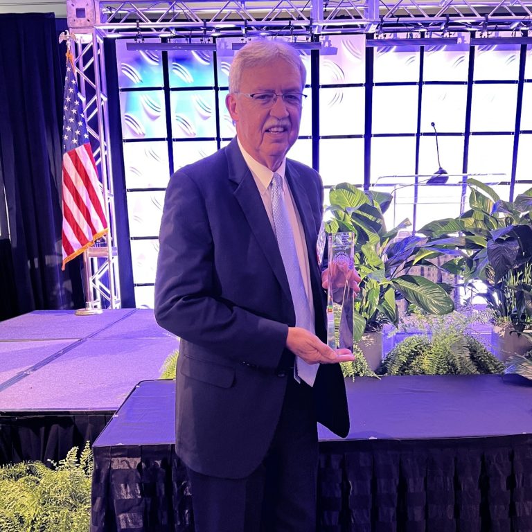 Man posing with an award